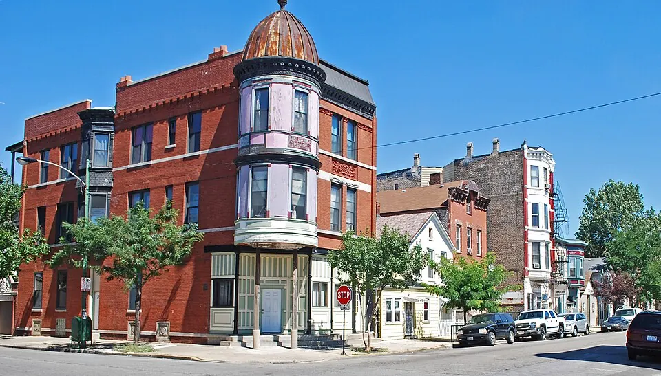 A red-brick corner building with a domed turret in the Pilsen Historic District